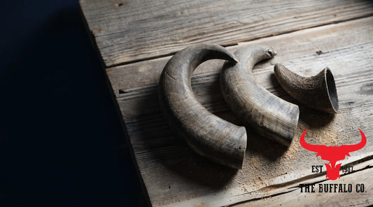 Three natural single-ingredient buffalo horn chews arranged on rustic wood, presenting them as the safer natural alternative to rawhide.