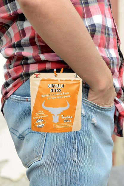Buffalo Bites treat pouch in orange and cream packaging, attached to a belt loop with a carabiner clip