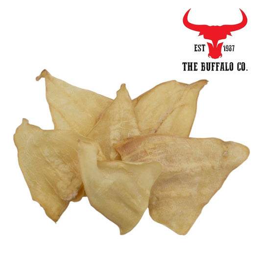 Buffalo Ears - Dog Treats are pale tan, dried natural chews with a thin, wrinkled texture and curved ear shape.