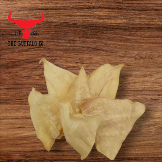 Buffalo Ears dog treats are pale golden natural chews with broad, flat shapes and a slightly wrinkled texture