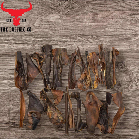 Buffalo Head Skin dog treats in dark brown, air-dried pieces with a naturally tough, irregular texture