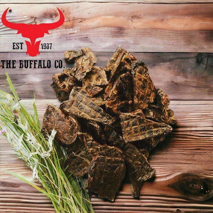 Buffalo Lung Steaks are dark brown, irregular dried buffalo lung pieces with a rough, chewy-looking texture.