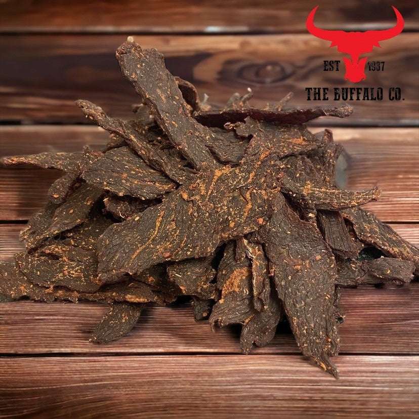 Buffalo Meat Jerky - Dog Treats with dark brown, irregular dried meat strips and a rough, textured surface.