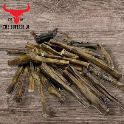Buffalo Tail - Dog Treats in natural dark brown shades, with long, dried, irregularly shaped chewy pieces