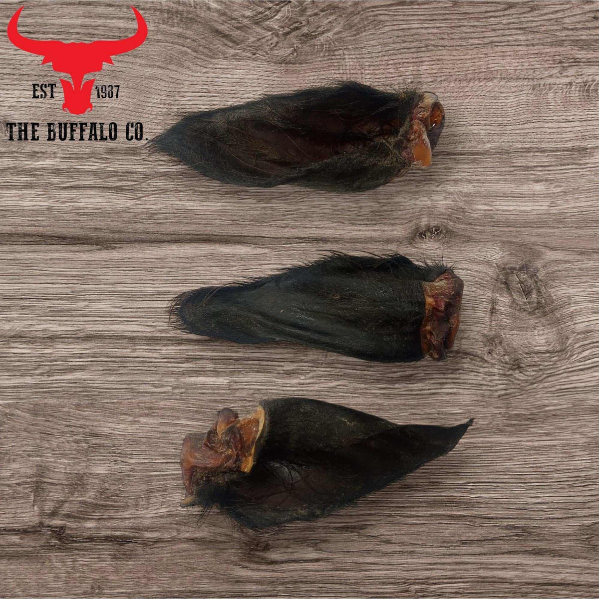 Hairy Buffalo Ears with Meat are dark, elongated buffalo ear treats with coarse fur and visible reddish-brown meat at the ends.