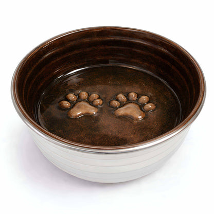 Dog bowl from The Poppy Collection with a glossy chocolate-brown interior, cream ribbed exterior and raised paw prints
