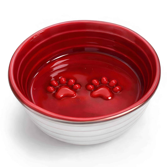 The Poppy Collection Dog Bowl in glossy red with a stainless steel exterior and raised paw-print details inside