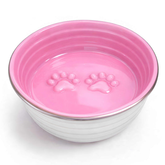 The Poppy Collection Dog Bowl in pink, with a glossy interior featuring raised paw prints and a ribbed white exterior